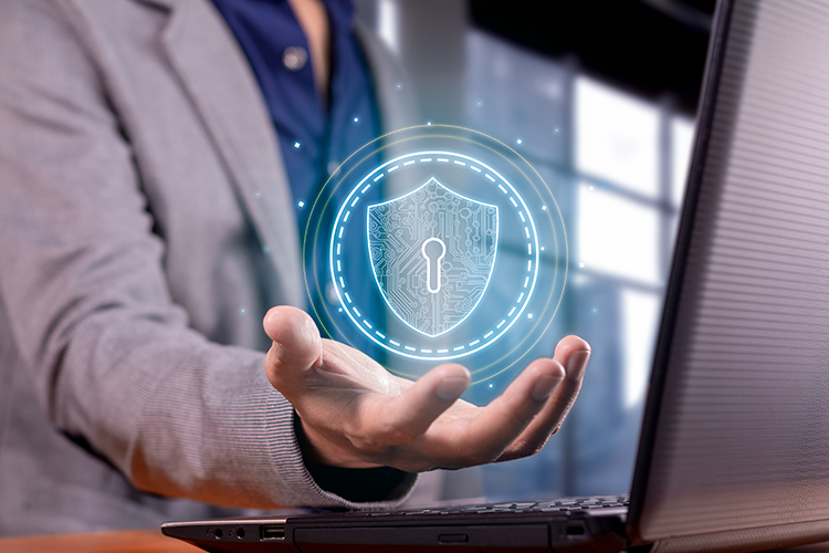 Praetorian Solutions website image of man with grey suit jacket and blue shirt virtually holding a see through image of a lock in his hand in front of a notebook computer. Praetorian Solutions install Ubiquity network components for highly secure network connectivity.